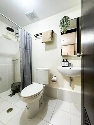a bathroom with a toilet and a sink at Kasara Urban Resort Residences by Amari Staycations in Manila