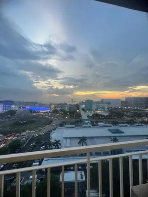 a view of a city from a balcony of a building at Shell Residences Mall of Asia Caitlin's Place in Manila