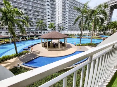 a view of the pool from the balcony of a apartment at Amazing Poolside 1br MOA Netflix 100mbps fiber in Manila