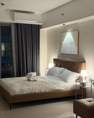 a bedroom with a bed with a stuffed animal on it at Bruné - Parañaque in Manila