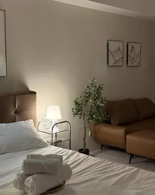 a bedroom with a bed and a couch at Bruné - Parañaque in Manila