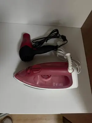 a red hair dryer with a brush in a box at European Vibe 1BR Great River City View Free Pool Gym Internet Netflix in Manila