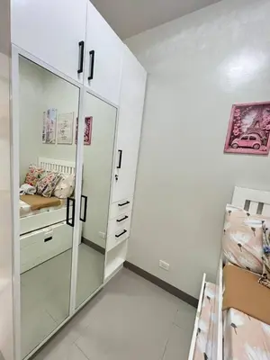 a bedroom with a large white closet with a mirror at Paris Theme Near Ayala Feliz Mall 2BR Netflix Internet with Pool Parking Fee in Manila