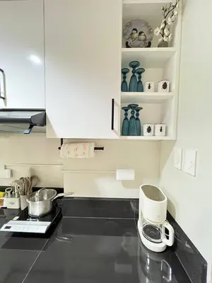 a kitchen with white cabinets and a counter top at Paris Theme Near Ayala Feliz Mall 2BR Netflix Internet with Pool Parking Fee in Manila