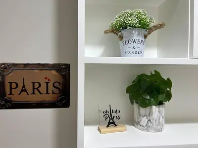 a shelf with a sign and a potted plant on it at Paris Theme Near Ayala Feliz Mall 2BR Netflix Internet with Pool Parking Fee in Manila