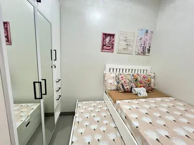 a small bedroom with a bed and a mirror at Paris Theme Near Ayala Feliz Mall 2BR Netflix Internet with Pool Parking Fee in Manila