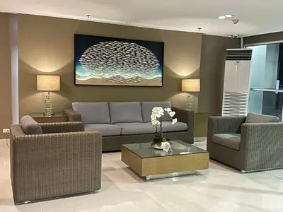a living room with a couch and chairs and a table at AMD Staycation in Manila
