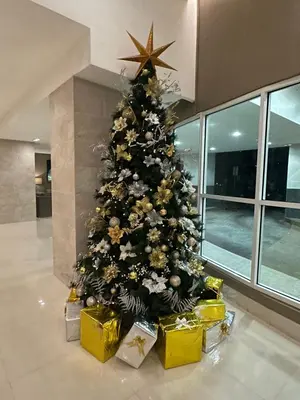 a christmas tree with presents under it in a building at AMD Staycation in Manila