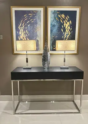 a black table with two lamps and two paintings at AMD Staycation in Manila