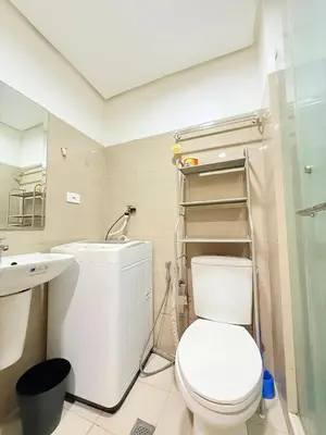 a bathroom with a toilet and a sink at Dreamstaycation shore residences in Manila