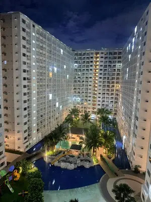 an aerial view of a large building at night at Dreamstaycation shore residences in Manila