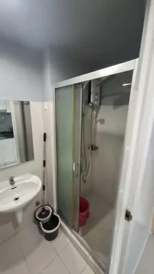 a bathroom with a shower and a sink at Sea Residences in Manila