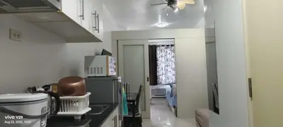 a kitchen with a ceiling fan and a microwave at Sea Residences in Manila