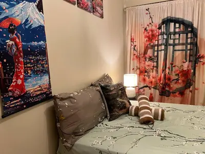 a bedroom with a bed with a painting on the wall at Japan Vibe near Ayala Feliz Mall 2BR 55sqm with Veranda Netflix Pool in Manila