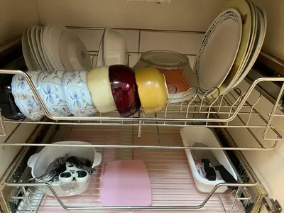 a drawer filled with dishes and a bottle of wine at Japan Vibe near Ayala Feliz Mall 2BR 55sqm with Veranda Netflix Pool in Manila