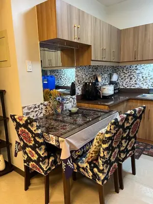 a kitchen with a table and chairs in a kitchen at Japan Vibe near Ayala Feliz Mall 2BR 55sqm with Veranda Netflix Pool in Manila