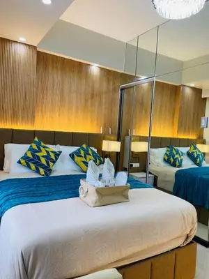 a hotel room with two beds and a mirror at 19s CAI in Manila