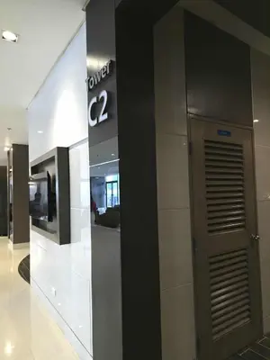 a lobby of a building with a sign on the wall at Kaizen Pod - Shore Residences Staycation, MOA Complex, Near airport in Manila