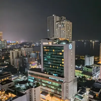 a city skyline at night with tall buildings at Birch Tower Ocean View Unit in Manila