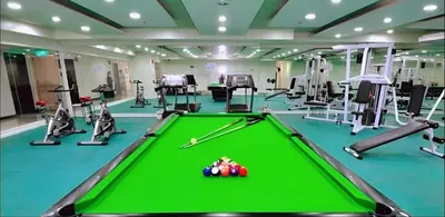 a pool table in a gym with exercise equipment at Birch Tower Ocean View Unit in Manila