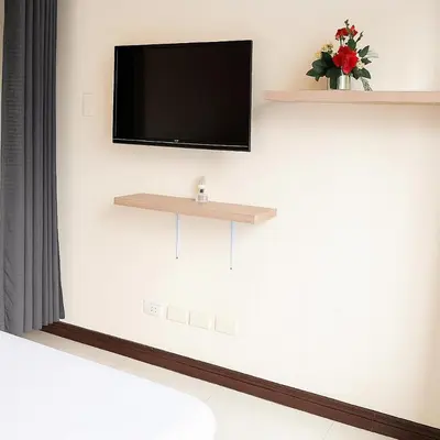a flat screen tv on a white wall at Birch Tower Ocean View Unit in Manila