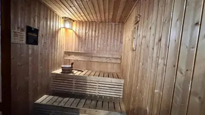 a wooden sauna with a bench in a room at AdahkuMaya Luxury Suites in Manila