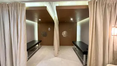 a dressing room with two mirrors and curtains at AdahkuMaya Luxury Suites in Manila