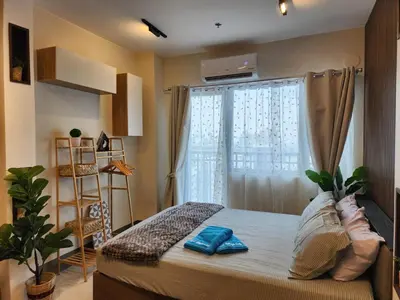 a bedroom with a bed and a window at Entire unit 1 Bedroom with City View - Paul Riley's Pad in Manila