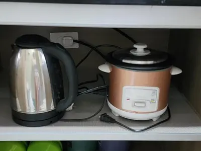 a coffeemaker and a coffee pot on a shelf at Entire unit 1 Bedroom with City View - Paul Riley's Pad in Manila