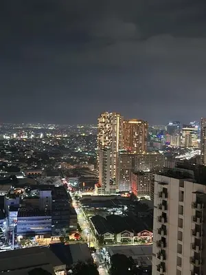 a view of a city at night with lights at Entire unit 1 Bedroom with City View - Paul Riley's Pad in Manila