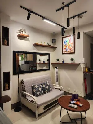 a living room with a couch and a table at Entire unit 1 Bedroom with City View - Paul Riley's Pad in Manila