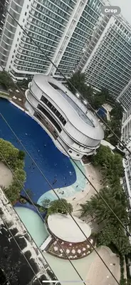 arial view of a large building in front of tall buildings at Urban Retreat at Azure in Manila