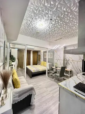 a living room with a bed and a table at Urban Retreat at Azure in Manila