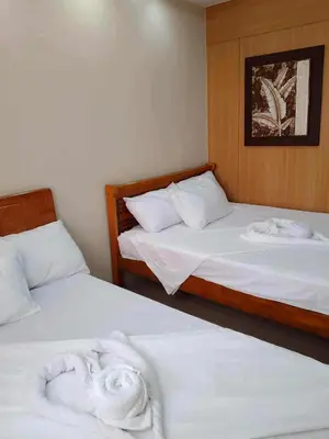 two beds in a room with towels on them at Family Suites 4 Shell Condo MOA 653B in Manila