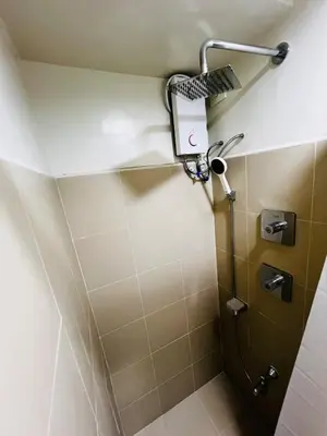 a shower in a bathroom with a shower head at Suite 07 MOA GRAND STAY Newly Turn over Only in Manila