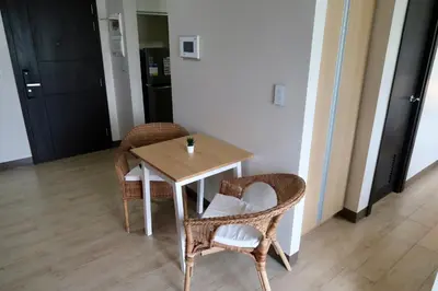 a table and two chairs and a table and a table at Bright & Cozy Condo Near Okada 2 mins walk in Manila