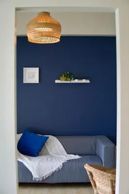 a blue living room with a couch and a blue wall at Bright & Cozy Condo Near Okada 2 mins walk in Manila