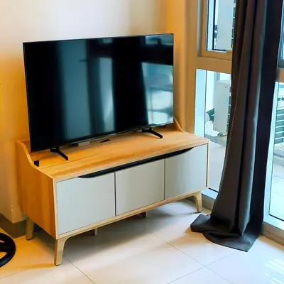 a flat screen tv sitting on top of a cabinet at Cozy Modernistic 1 BR with Veranda! in Manila