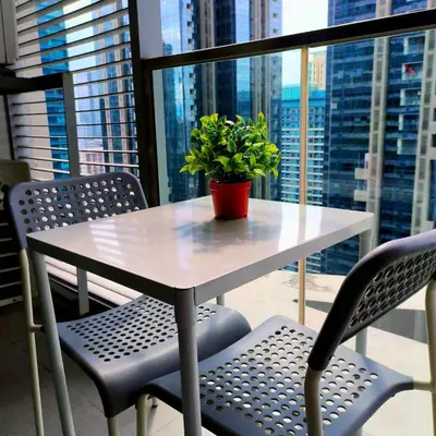 a table with a potted plant on top of a window at Cozy Modernistic 1 BR with Veranda! in Manila