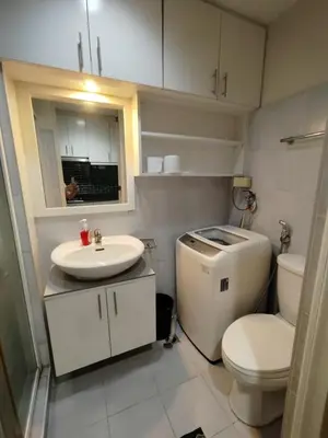 a small bathroom with a toilet and a sink at Sea residences MOA-MR in Manila