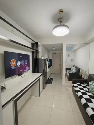 a living room with a tv and a couch at Sea residences MOA-MR in Manila