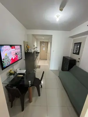 a living room with a couch and a table at Sea Residences Vertex in Manila