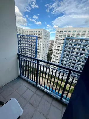 a balcony with a view of some tall buildings at Sea Residences Vertex in Manila