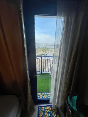 a door leading to a balcony with a view at Sea Residences Vertex in Manila