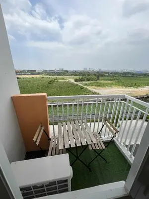 a balcony with a bench and chairs on a balcony at 2 bedroom modern unit in Manila