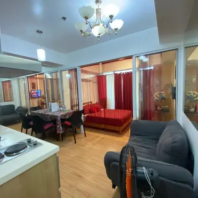 a living room with a couch and a table at 320 Santorini Staycation in Manila