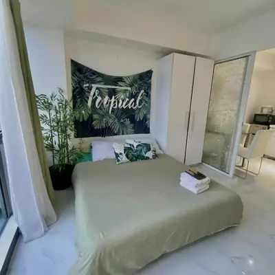 a bedroom with a bed and a sign that reads furnished at 320 Santorini Staycation in Manila