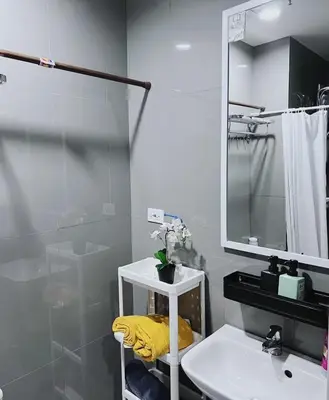 a bathroom with a sink and a mirror at Pleasant Air Residences City View in Sampong