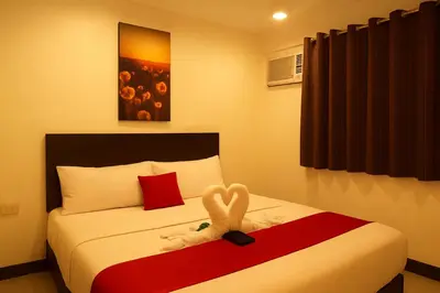 a bedroom with a bed with a stuffed animal on it at City Stay Inns Slex Makati in Manila