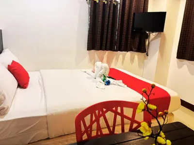 a bedroom with a bed with a toy monkey on it at City Stay Inns Slex Makati in Manila